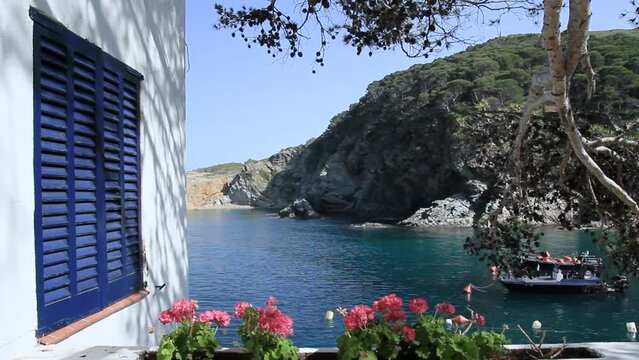 Partial view of the cove with detail of blue window and white walls typical of the area. Sa Tuna, Begur, Costa Brava, Catalonia, Spain.
