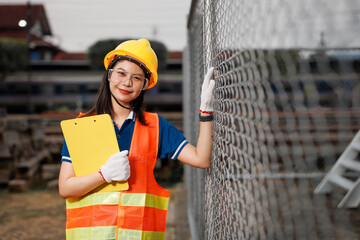 portrait Asian young teen engineer worker standing happy smile outdoor waring safety reflective with hardhat. - 793844235