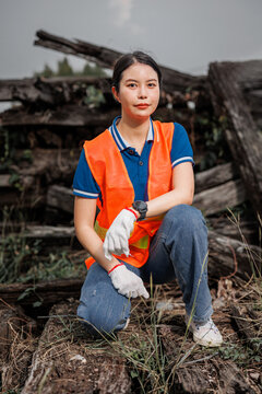 portrait Asian young teen engineer worker standing happy smile outdoor waring safety reflective with hardhat.