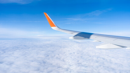 Obraz premium air plan wing, blue sky and clouds, view from windows. High quality photo