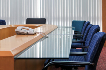 Meeting or conference room with telephone, table and armchairs. It is a workspace or coworking space in modern office.