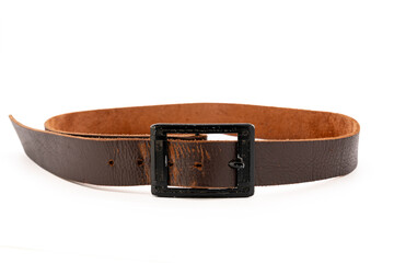 Worn Men's leather belt in a dark brown color with a metal buckle on white background. Side view, close-up.