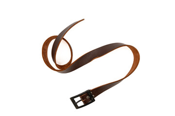 Worn Men's leather belt in a dark brown color with a metal buckle on white background. Top view or flat lay.