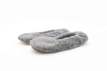 Fluffy gray home slippers isolated on white background. Bed shoes accessory footwear. Side view, close-up.