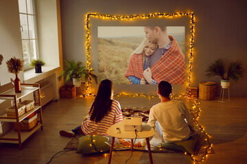 Young couple enjoying Valentine's Day, having romantic date at home, having good time together,...