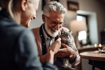 Elderly Man Holding A Cat And Smiling, Talking With Daughter On A Kitchen