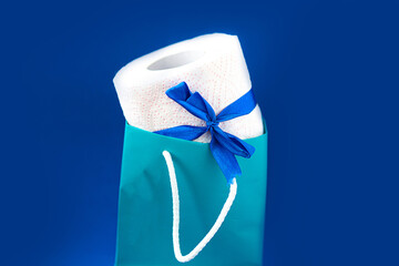 Toilet paper roll in gift box on blue background. Covid19 concept. Quarantine concept