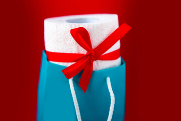 Toilet paper roll in gift box on red background. Covid19 concept. Quarantine concept