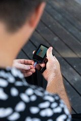 Men checking their sugar levels using a lancet pen and a glucometer in the city
