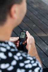 Men check their sugar levels using a lancet pen and glucometer