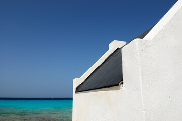A colorful house on a Bonaire beach - Powered by Adobe
