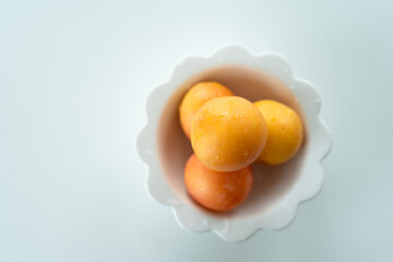 a bowl of yellow plum