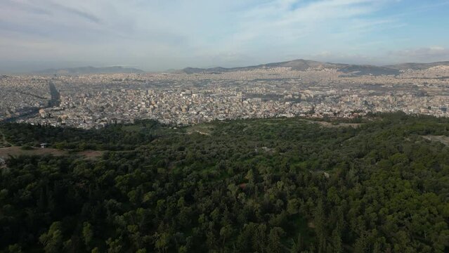 Drone aeial view of Athens city with Green nature Forest park in Acropolis in Greece, Parthenon in Athens drone aerial view, famous Greek tourist attraction