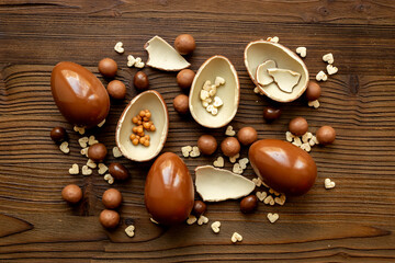 Chocolates background with chocolate eggs and sweets, top view