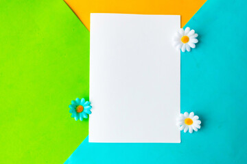 White mockup blank on geometric green, blue and yellow background