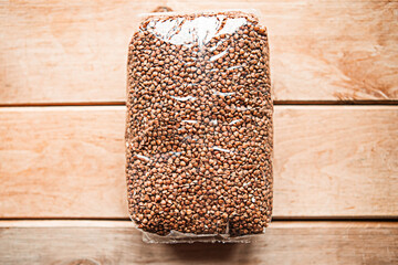 packages of buckwheat on wooden background