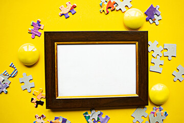 White mockup photo frame and puzzles on bright yellow background. Stay Home concept