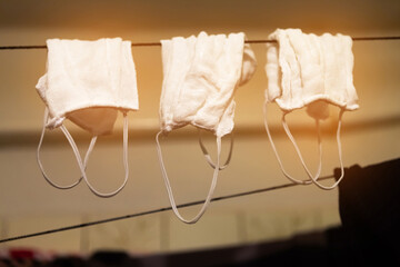 Medical masks are dried on a clothesline. Covid-19 concept.