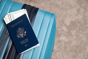 US citizen passport and American dollars lie on the baggage for travel.