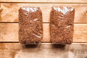 packages of buckwheat on wooden background