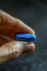  holding blue pills that say the strategy
