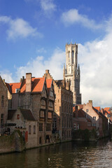Rozenhoedkaai, (Rosary Quay), Bruges, Belgium: the Belfry Tower dominates the medieval gabled canalside buildings in this classic view of Bruges.
