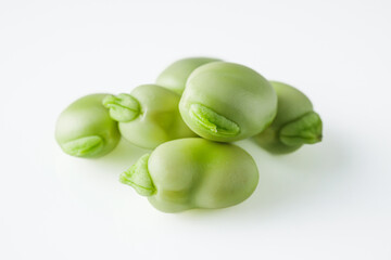 fresh greens broad beans fava on a white background