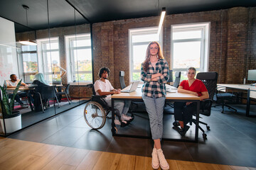 A diverse group of business professionals collaborates in a modern startup coworking center, utilizing a mix of paper-based and technological tools such as mobile phones and computers 