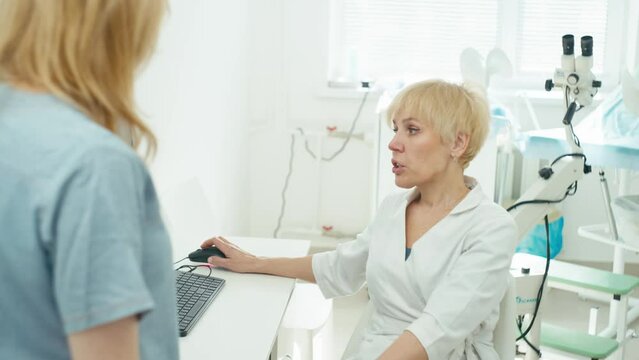 A meeting of colleagues to discuss important issues of the clinic. A colposcope and a gynecologicals chair can be seen in the background. High quality 4k footage