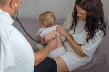 Pediatrician hold stethoscope exam baby. Children medical care