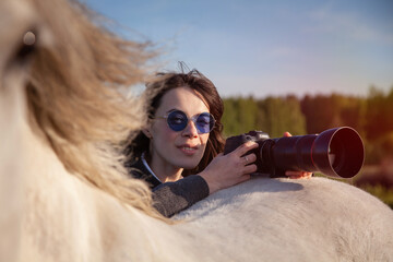 beautiful woman making pictures of horse