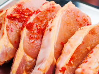 Pork chops in red Asian style marinade with chilly pepper. Fine pork meat for grill or summer barbecue. Popular dish with rich flavor.