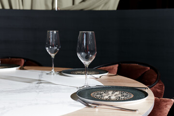 Chic dining setup featuring an intricate eastern plate on a marble table, poised for a luxury meal...