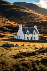 Scenery of alone traditional Scottish white croft house cottage in rural highlands. Mountain landscape countryside in summer sunny day. Nature Scotland concept. Gen ai illustrate. Copy ad text space