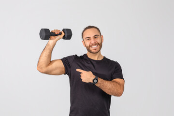Man Holding Dumbbells, Pointing at His Muscles