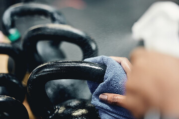 Cleaning, kettlebell and person in gym, safety and maintenance of health, hygiene and wellness....
