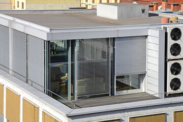 Office Cube Space at Building Roof Top With Closed Blinds on All Windows