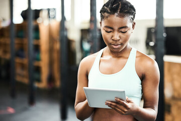 Gym, healthy and black girl with tablet, workout and videos for fitness, practice and sports...