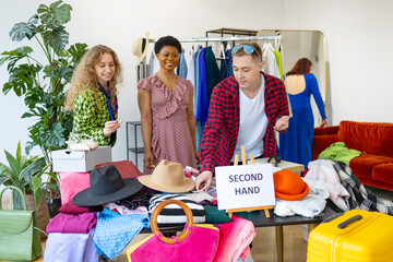second-hand store, saving money and family budget, young people students at swap party try on clothes, bags, shoes and accessories, change clothes with each other, second hand for things, zero waste