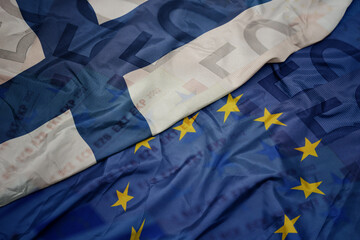 waving colorful flag of european union and national flag of finland.finance concept.