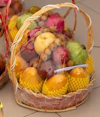 Tropical fruits in baskets at the market - 793900890