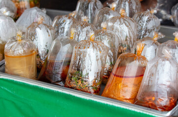 Soups in a bag on the counter. Street food in Thailand - 793900896