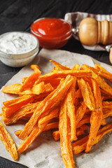 sweet potato fries on a dark wooden rustic background