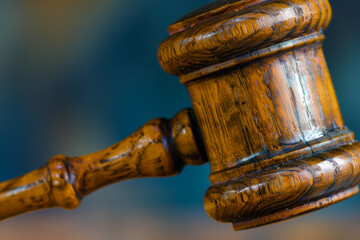 detailed close-up image of an aged gavel, emblematic of the authority and solemnity associated with legal proceedings in the old-fashioned concept of the legal system, against a si - obrazy, fototapety, plakaty