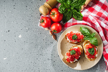 delicious Italian bruschetta with tomatoes on a light stone background