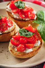 delicious Italian bruschetta with tomatoes on a light stone background