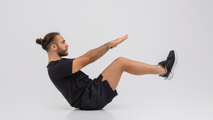 Man in Black Shirt and Shorts Doing a Stretching Exercise