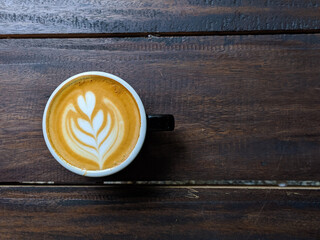 close up glass of cofcoffee, beverage, cup, drink, espresso, hot, isolated, white, black, cappuccino, breakfast, cafe, mug, morning, caffeine, design, brown, fresh, lattfee on a wooden table in a cafe