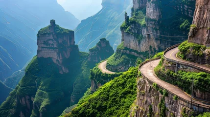 Foto op Canvas A winding mountain road clinging to the edge of sheer cliffs, offering breathtaking views and heart-pounding thrills for adventurous travelers. © chanidapa