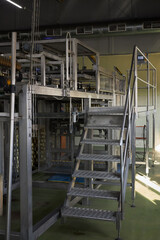 Staircase with a platform in a production workshop of the food industry.